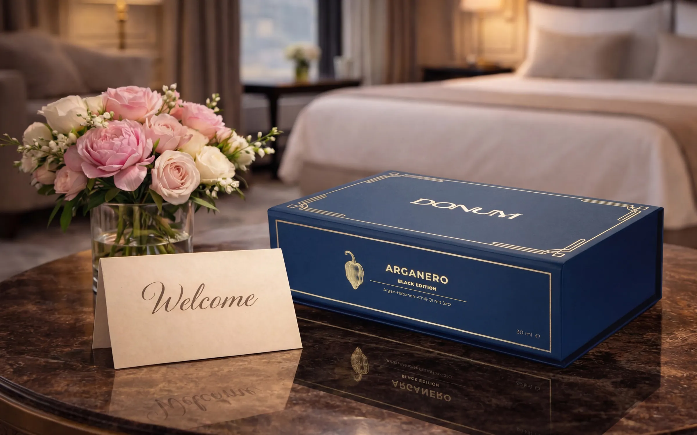 The DONUM gift box with a welcome card and roses in a hotel suite